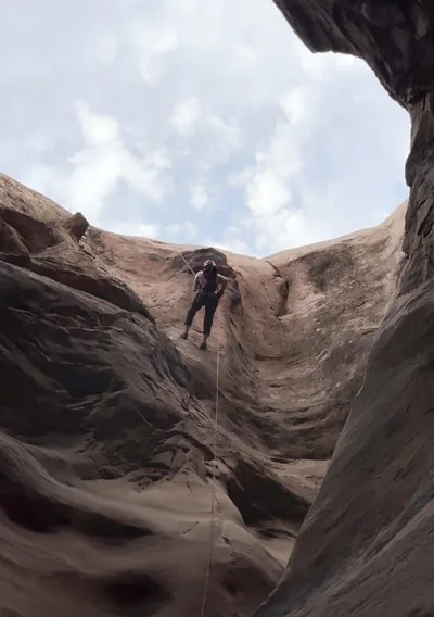 Rappelling into a canyon